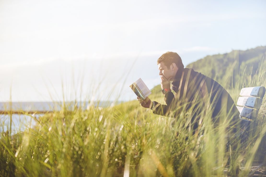 man reading in nature